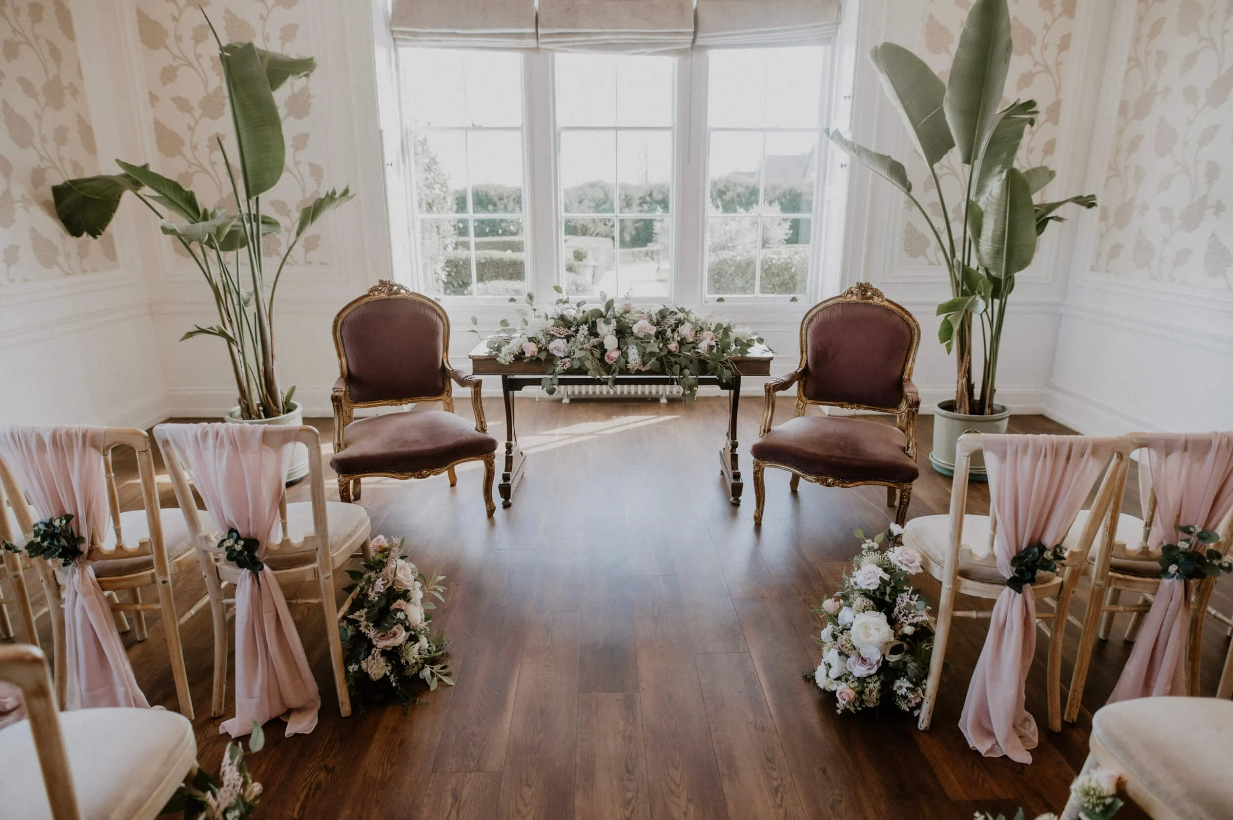 Faux Florals - Small Floral Meadow Arrangement with soft pink and white flowers and greenery on a wooden table, available to hire for your wedding or event.