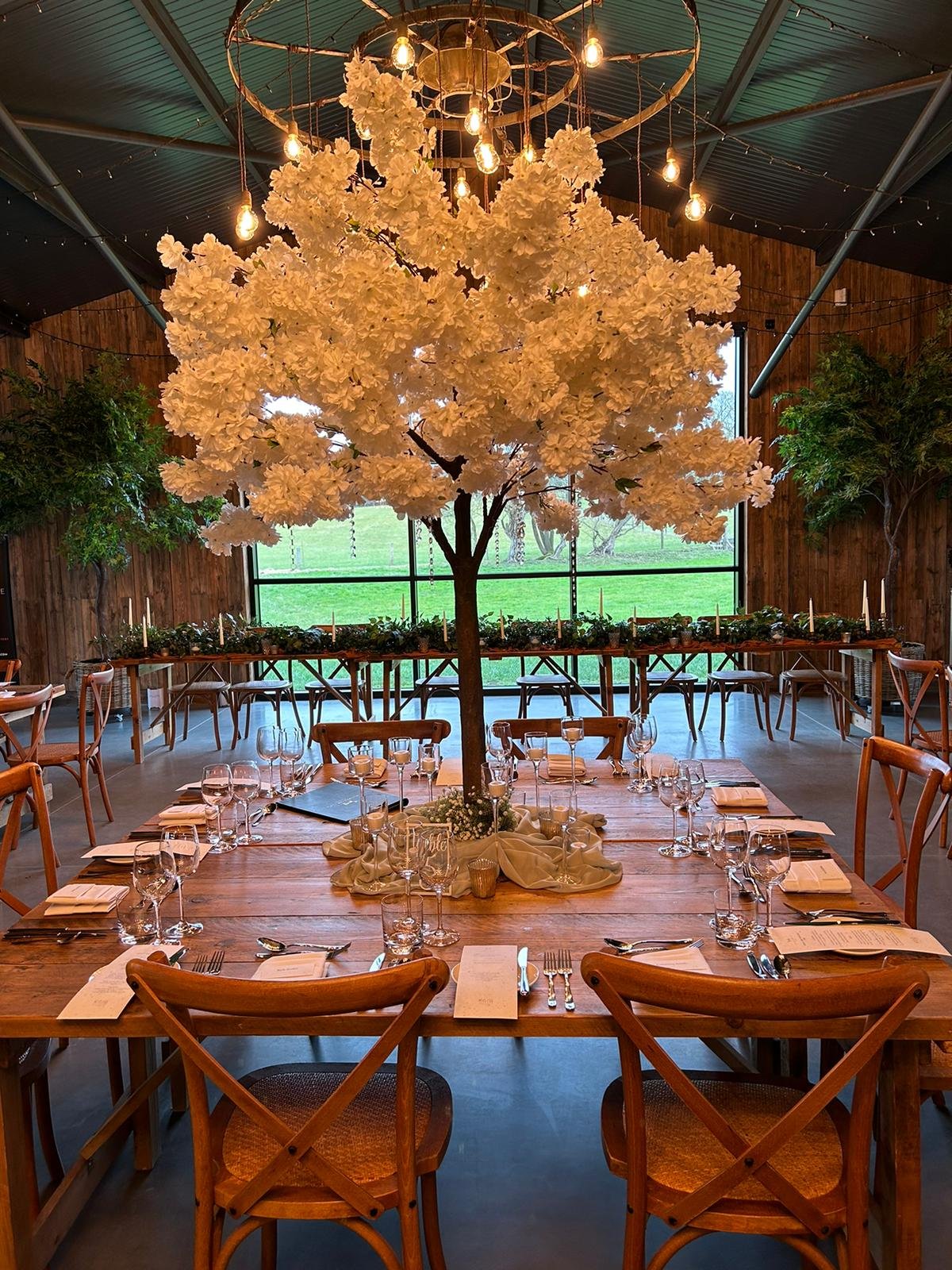 1.8m wedding table trees used as statement centrepieces in blossom, greenery and autumn styles