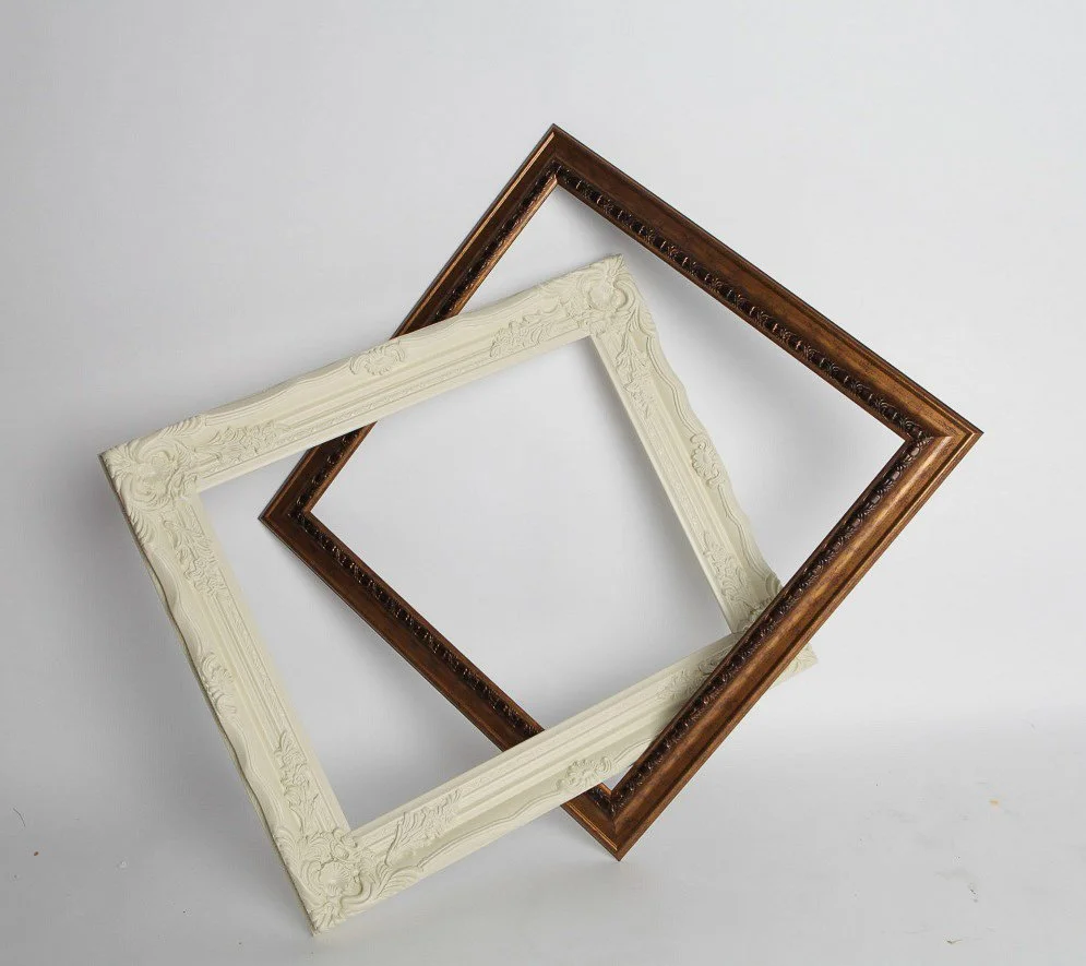 Decorative empty wedding photo prop frames in white, cream and brown finishes