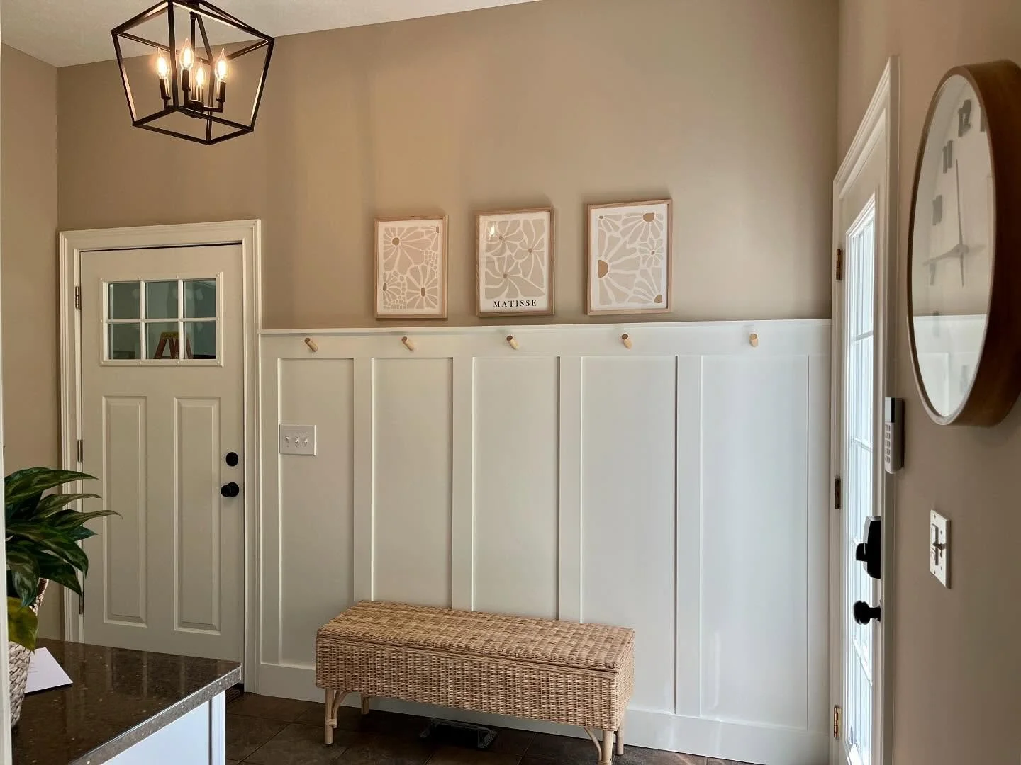 A lovely entrance utilizing board and batten, sw Alabaster white, Valspar Lambs Ear and a few art pieces to tie together the warm and inviting space 🌤️