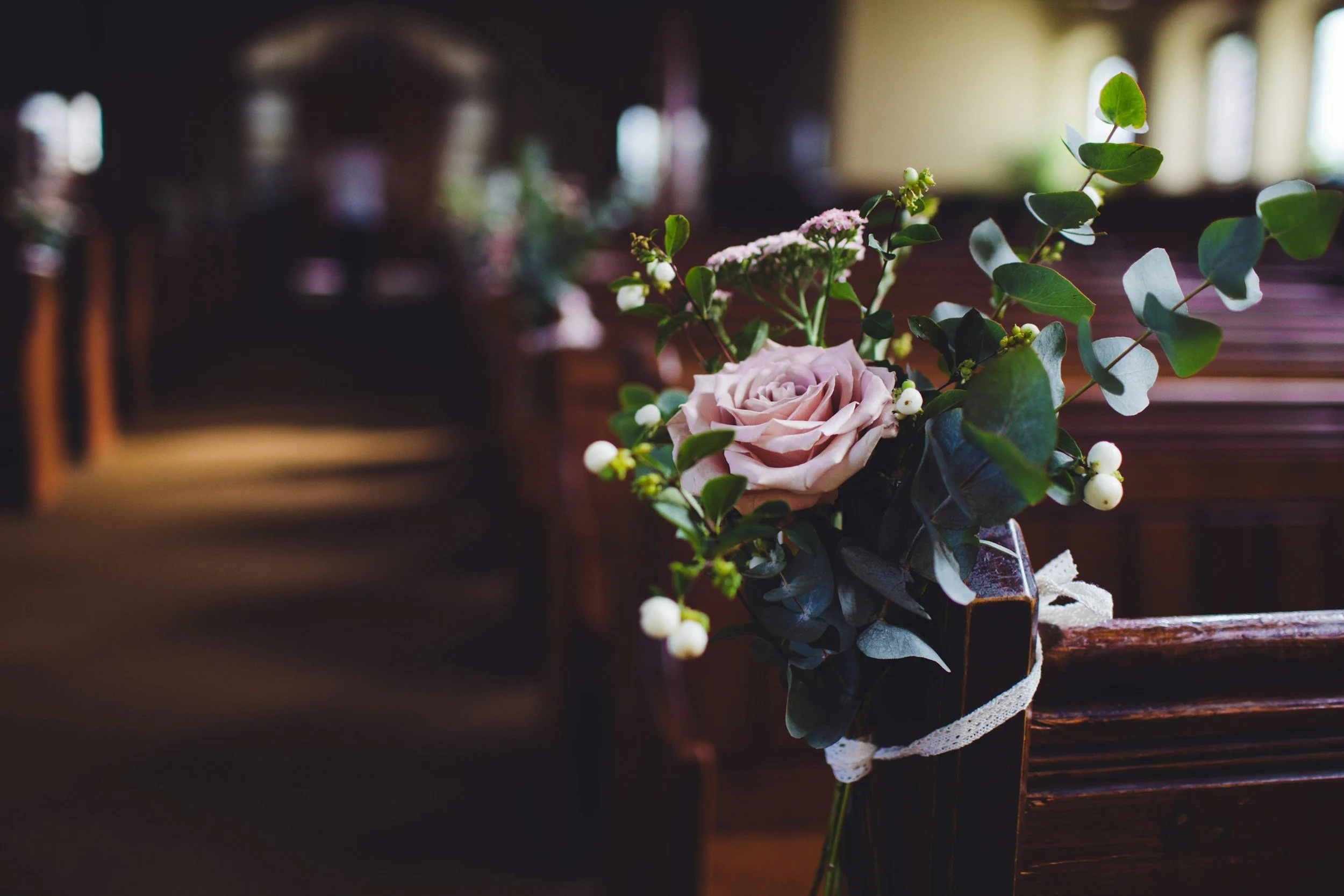Flowers attached to church pew