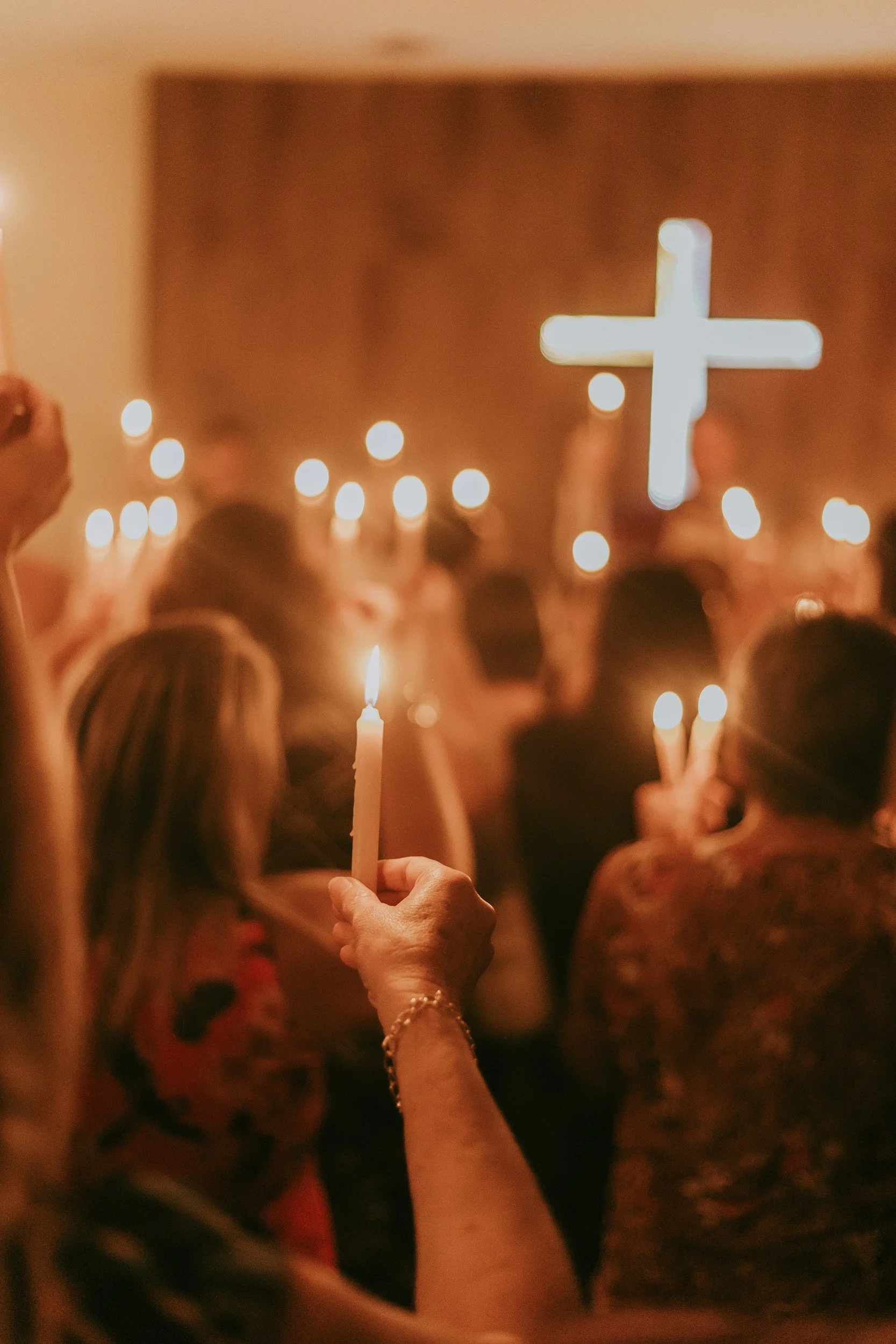 people in church holding candles