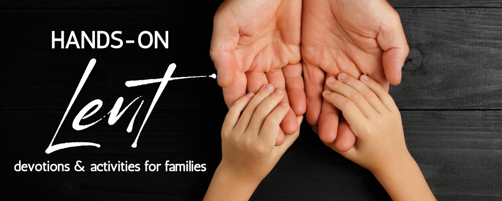 Child hands holding adult hands