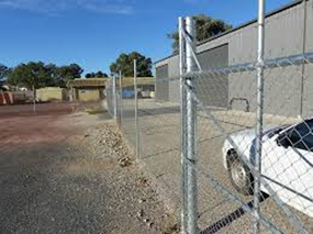 Typical barbed wire topped “chain-link” perimeter fence