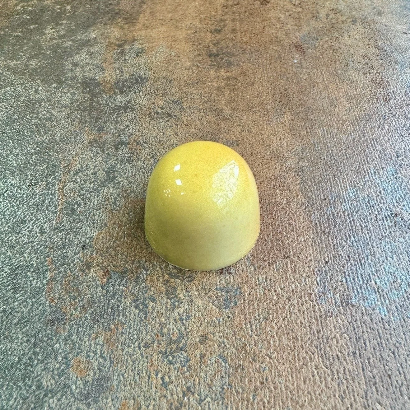 Yellow shiny chocolate bonbon