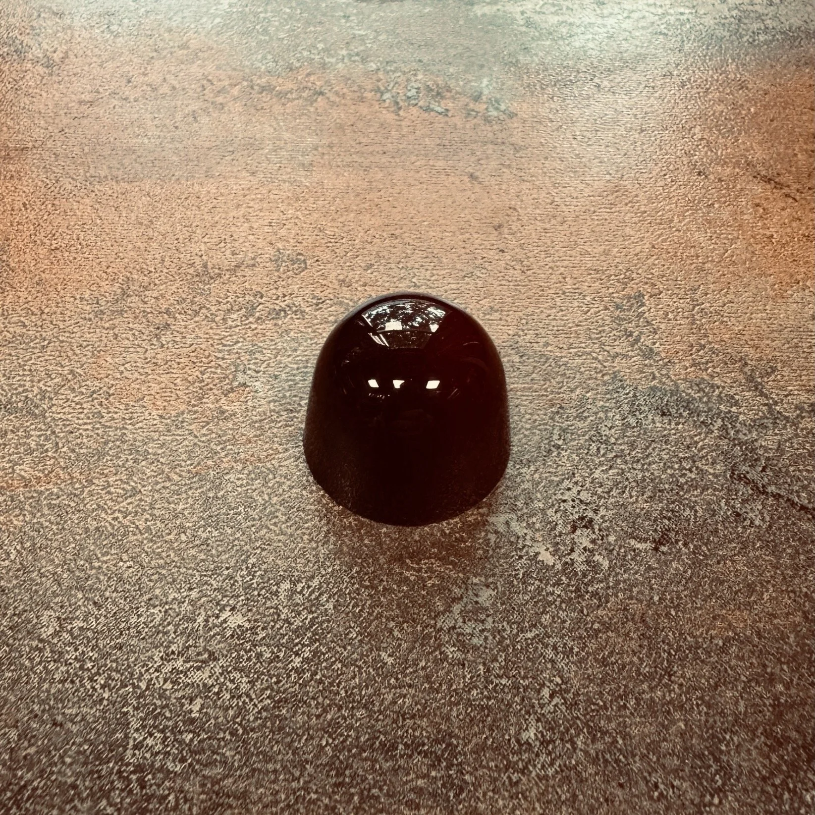 Dark red domed bonbon