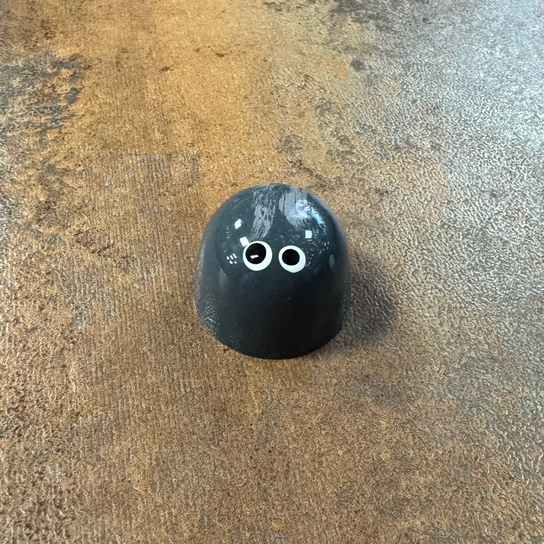 Grey shiny bonbon with 2 white eyes