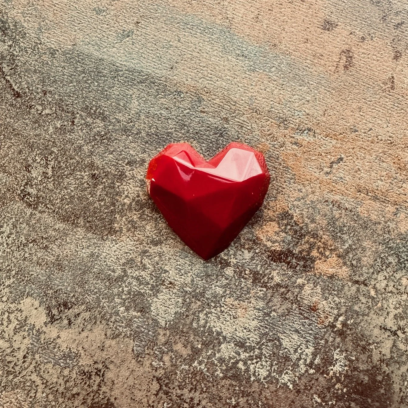 Red heart shaped bonbons with diamond-like facets