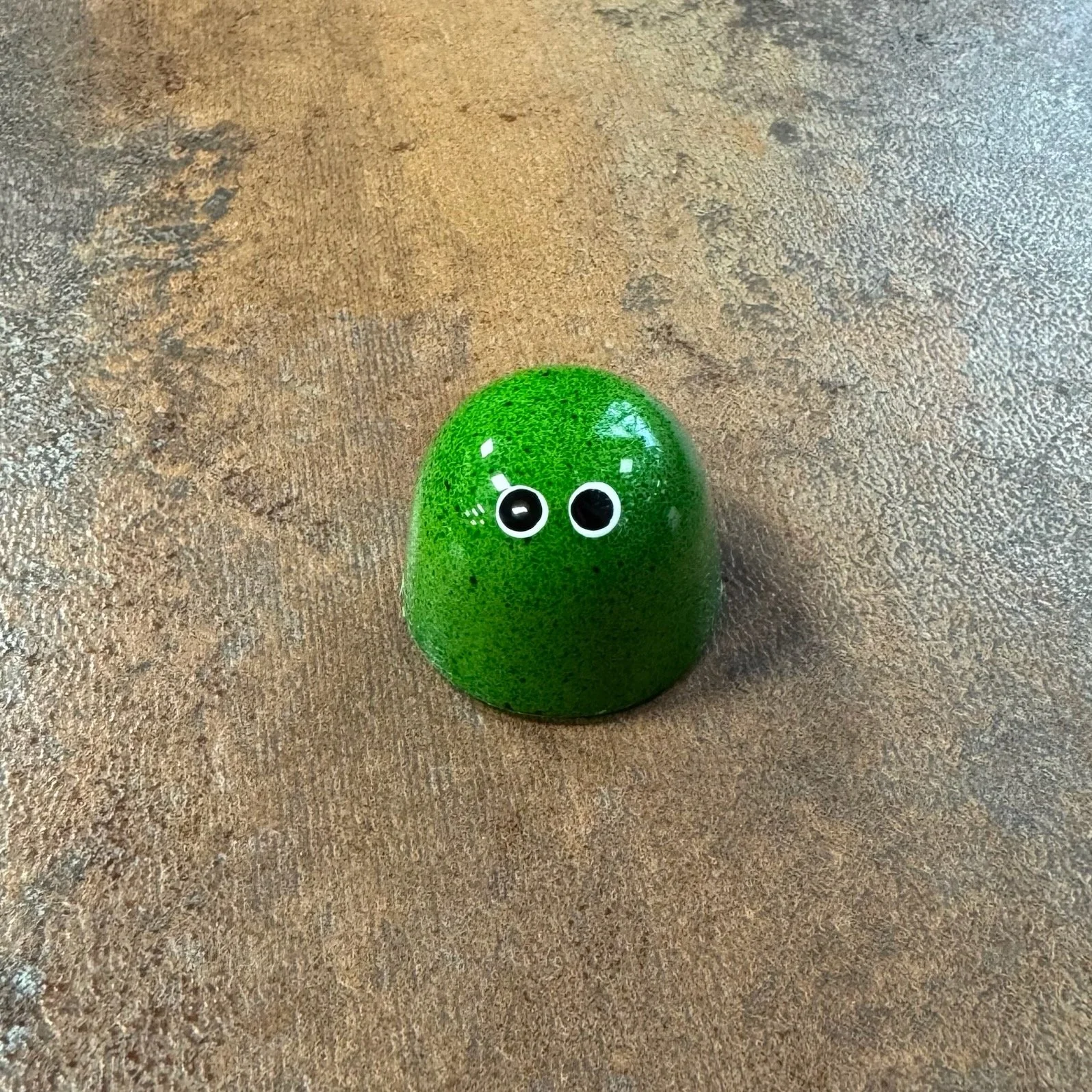Green shiny bonbon with 2 white eyes