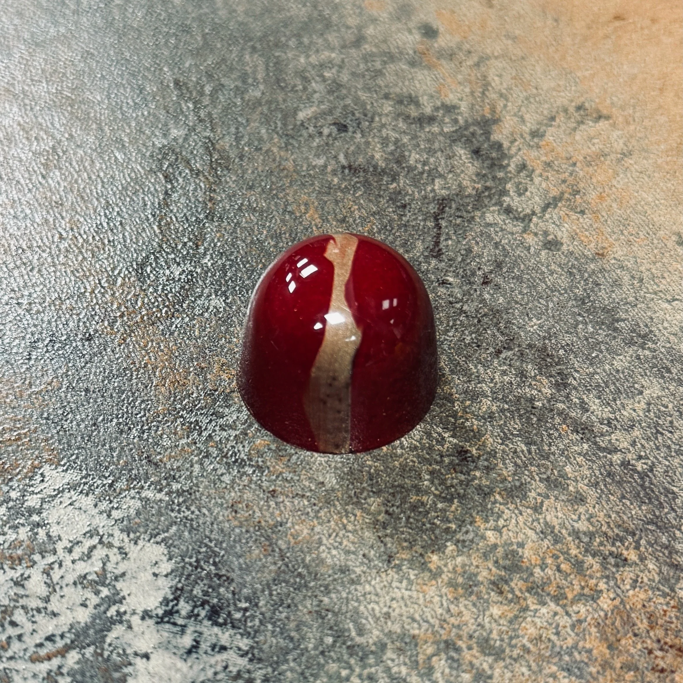 Dark red and gold domed bonbon