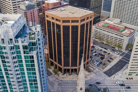High-angle aerial view of commercial high-rise buildings and corporate offices in downtown Denver, representing large-scale commercial fire extinguisher inspection and safety compliance services.