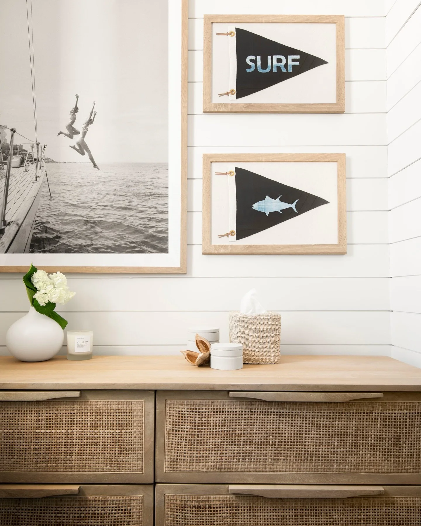 Salt in the air, summer is around the corner. This powder bath vignette is giving us all the coastal summer vibes &mdash; pennant flags, cane drawers, and a black-and-white print that says jump in. 🌊

Photography &mdash; @reedjamesk