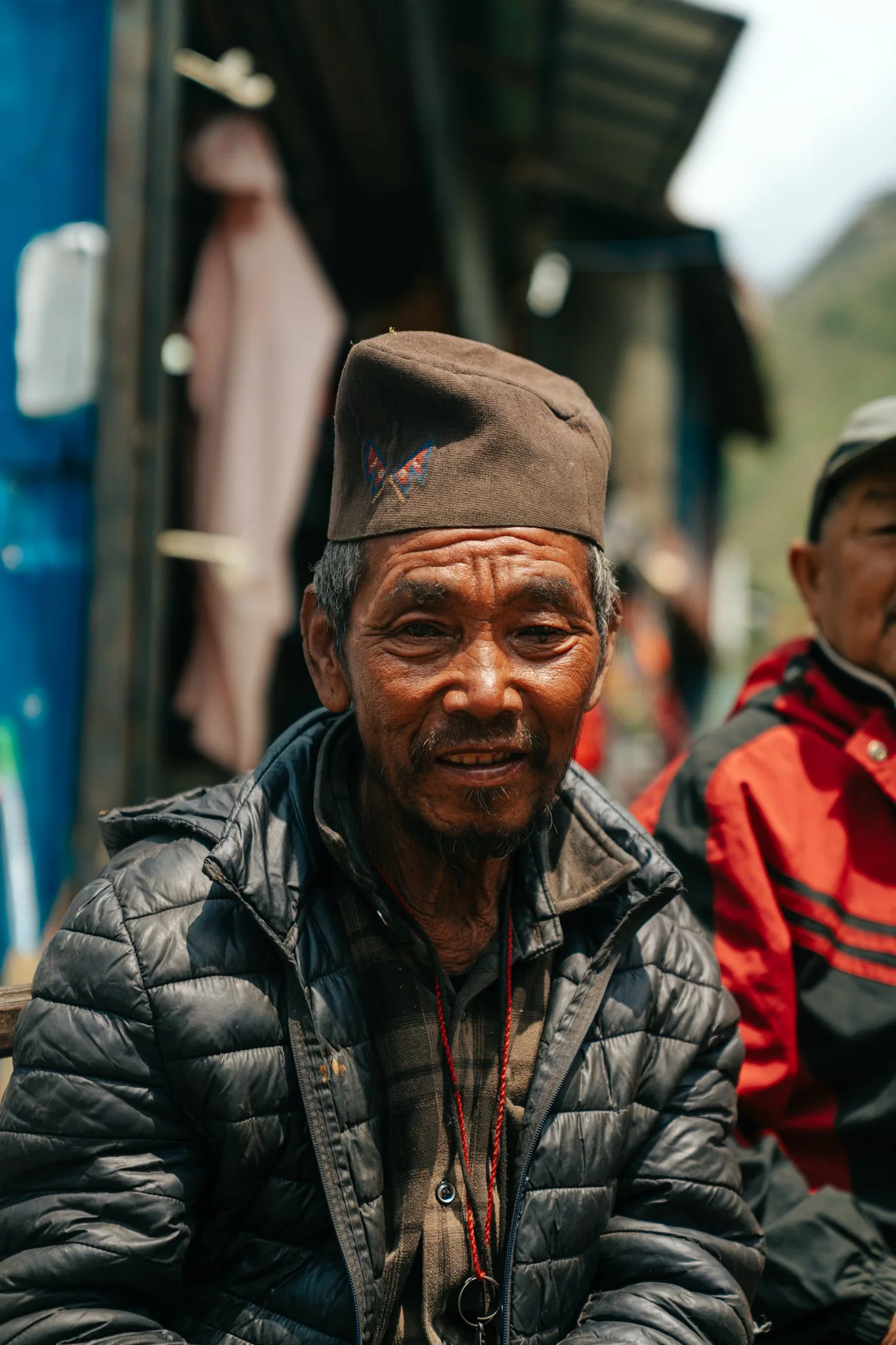  Portrait of an elderly Nepali man wearing a traditional dhaka topi hat in the village of Philim on the Manaslu Circuit Trek 