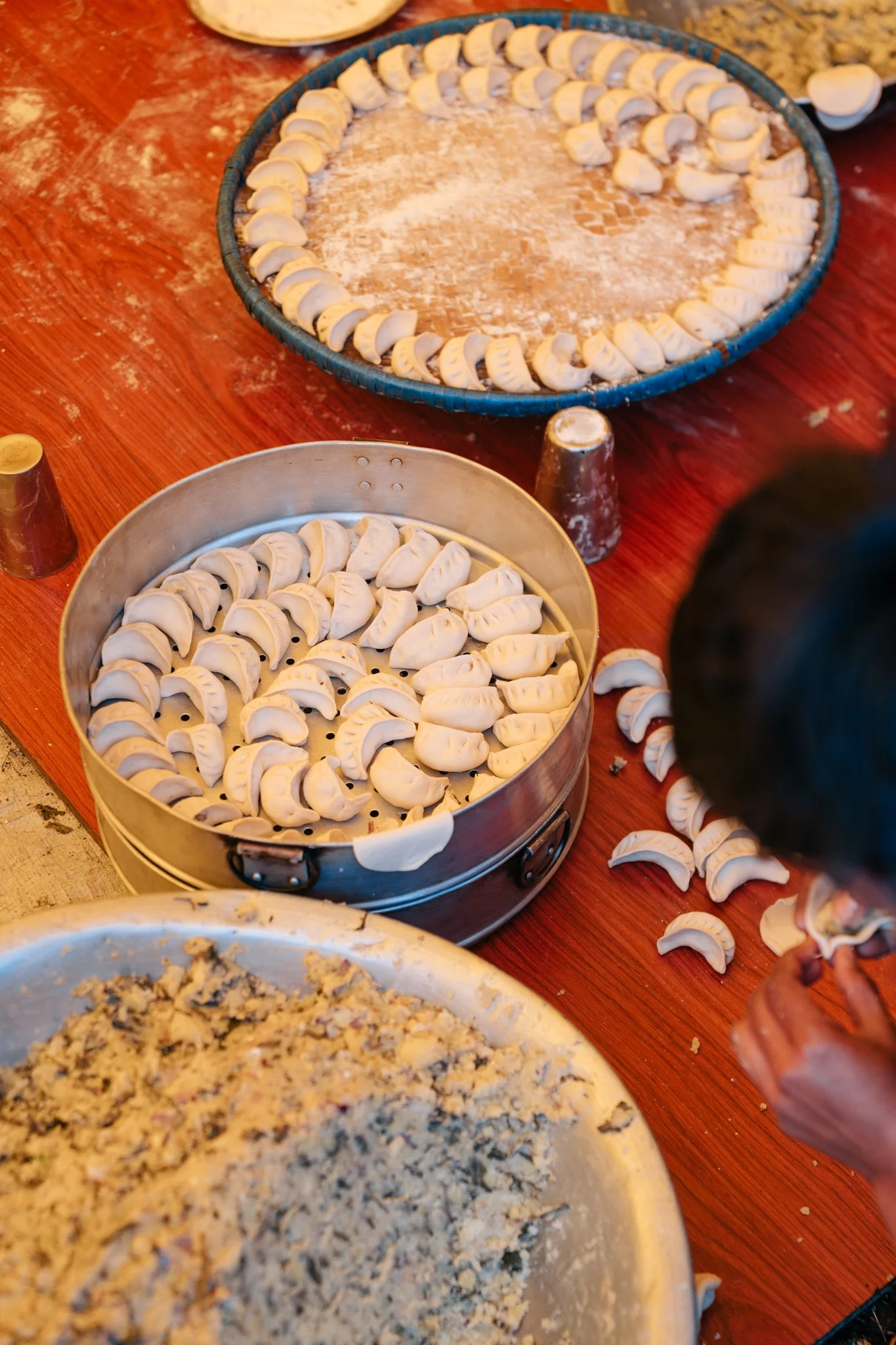 Saga Dawa momos. Hundreds. All hand-folded by the village's twenty-somethings.