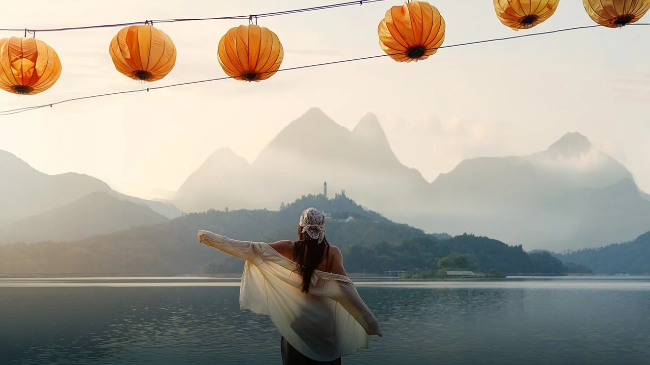 Beautiful mountain scape with girl in the foreground looking out to sun moon lake at sunrise from the famous viewpoint