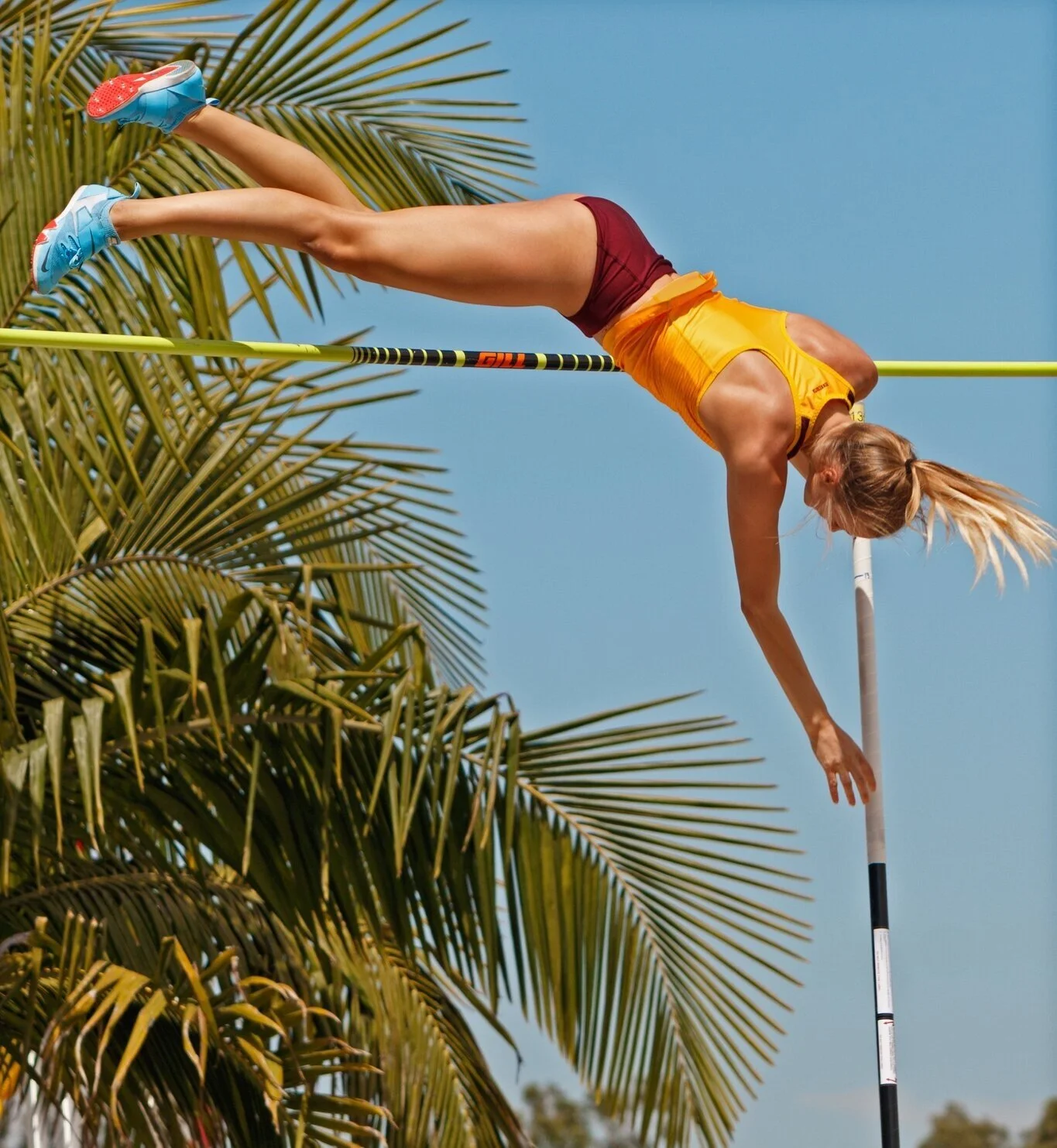 Karlie Place pole vaulting at a college track meet