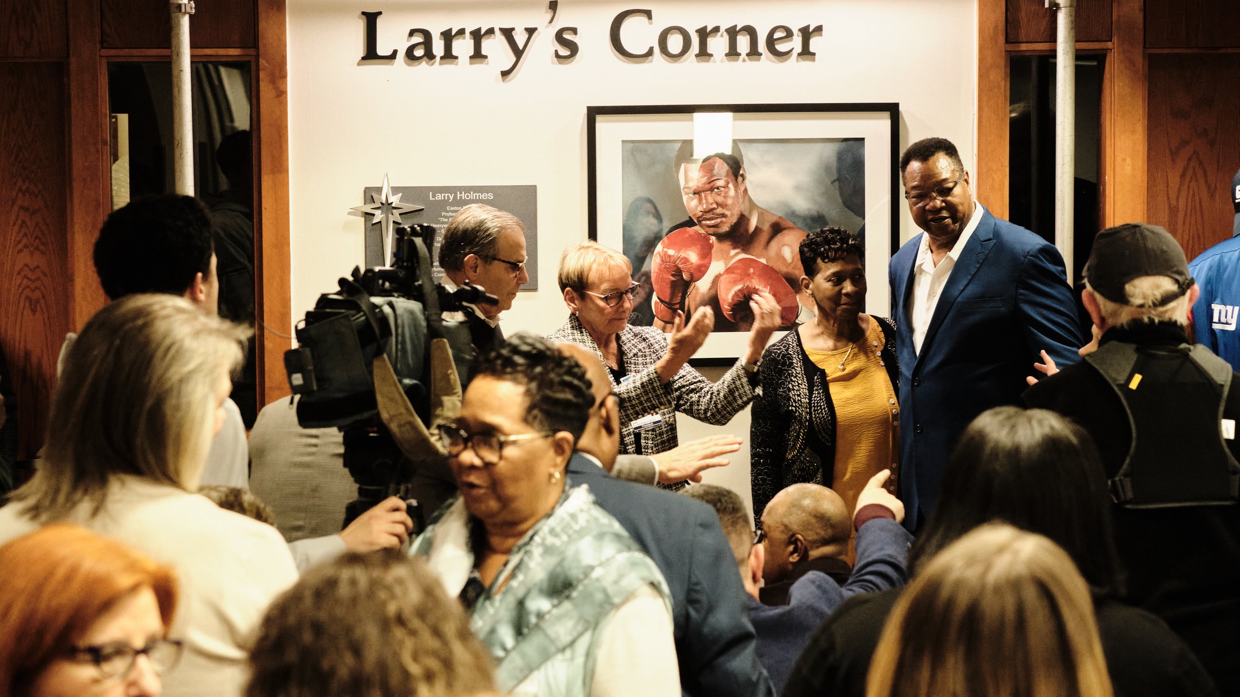 Boxing legend Larry Holmes stands next to a newly unveiled portrait of himself in his boxing prime Feb. 26, 2025, at St. Luke's University Hospital Network's Easton Campus.