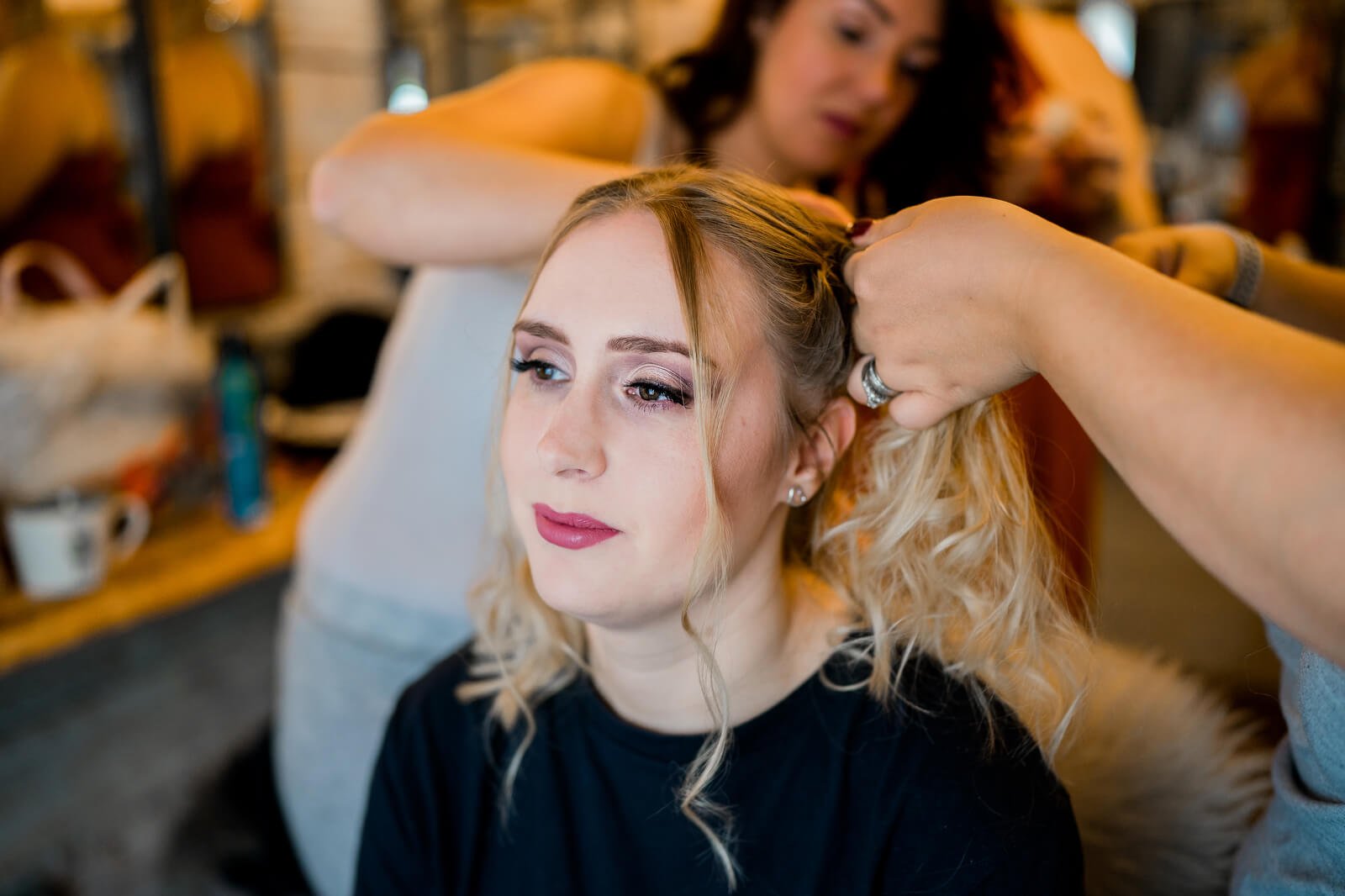 bride having hair done at silchester farm wedding venue during bridal preparations