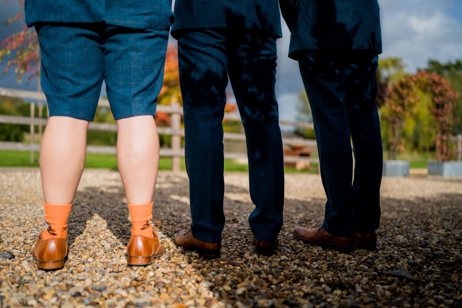 groomsman wearing suit with shorts at candid photo of bride at silchester farm wedding wedding