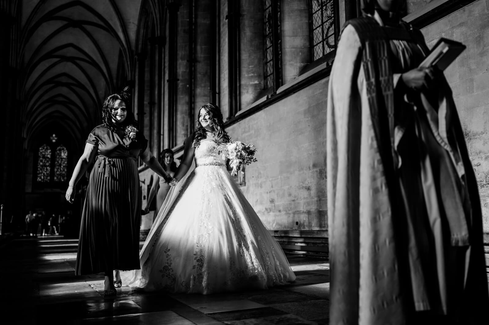 bride walking down aisle at salisbury cathedral wedding