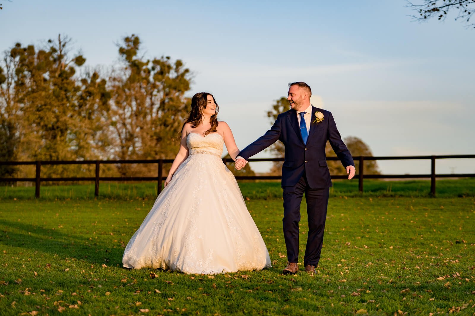 relaxed sunset wedding photo of couple laughing at Barford Park barn wedding venue