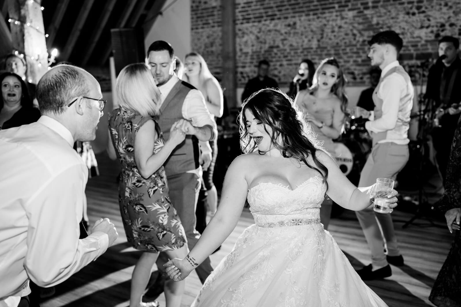 bride dancing at barford park wedding venue with band the deloreons