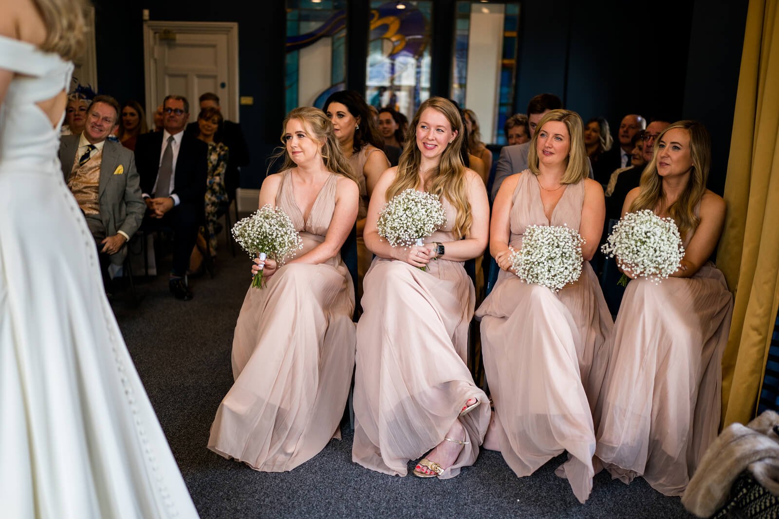 bridesmaids during wedding ceremony in castle room at winchester register office