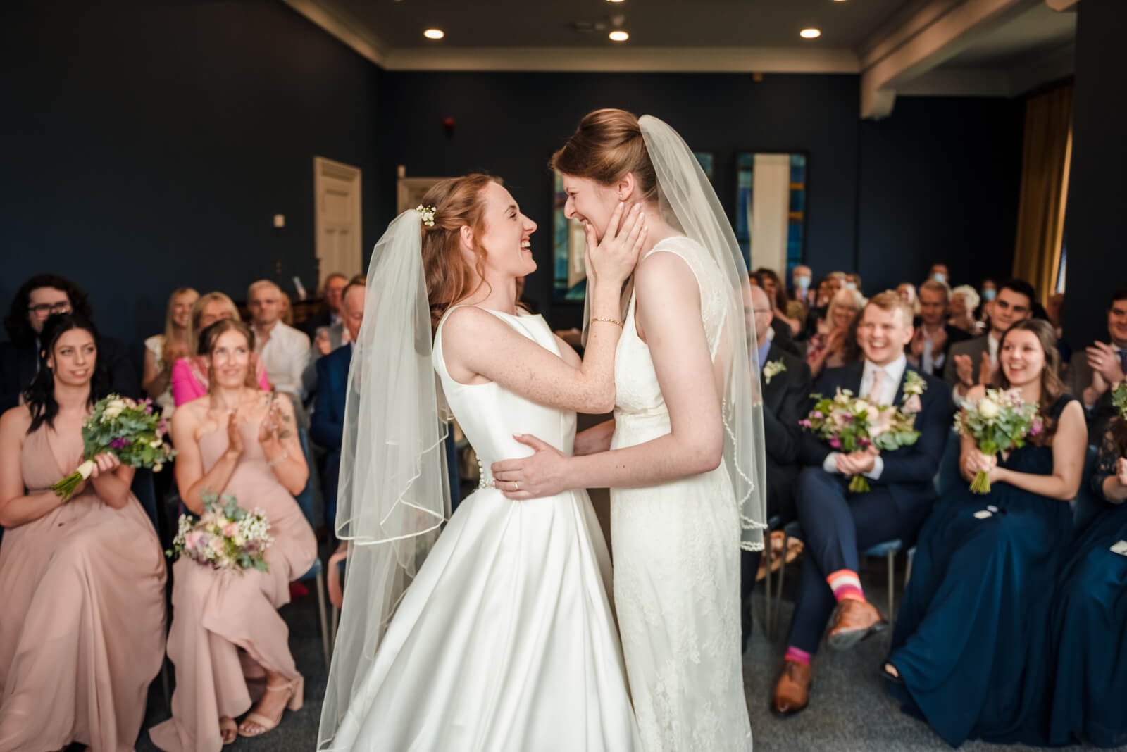 brides get married same sex wedding in castle room at winchester register office