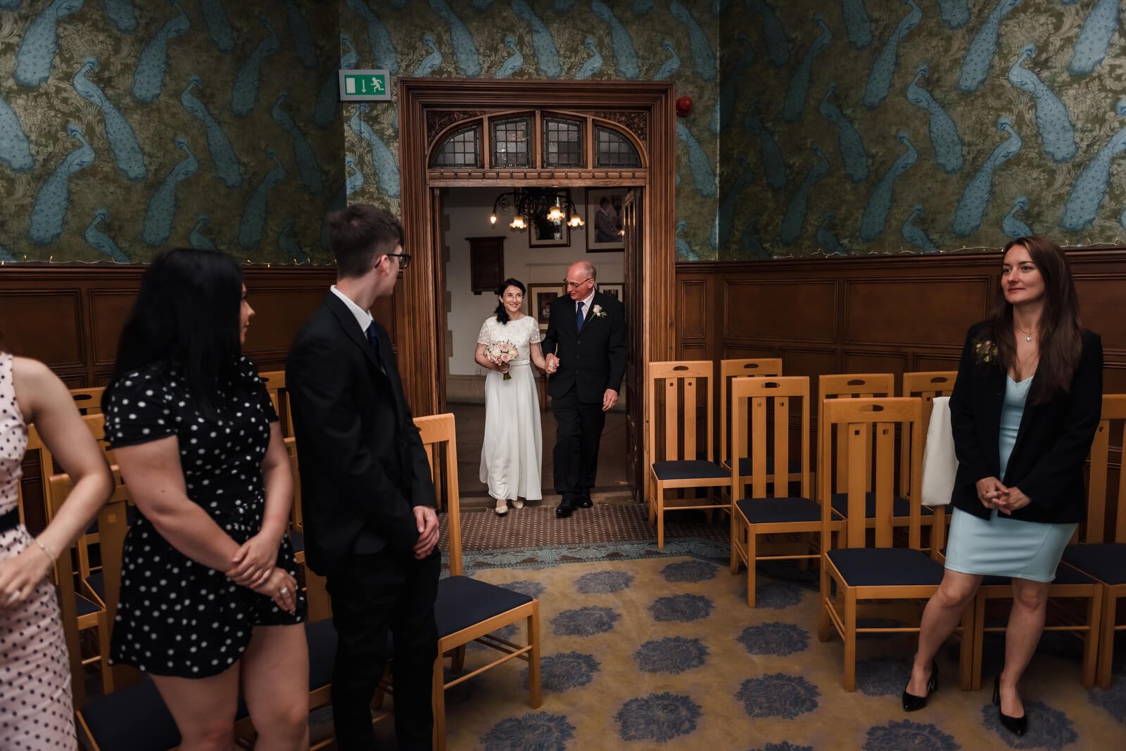 bride and groom enter wedding ceremony in basing room at winchester register office