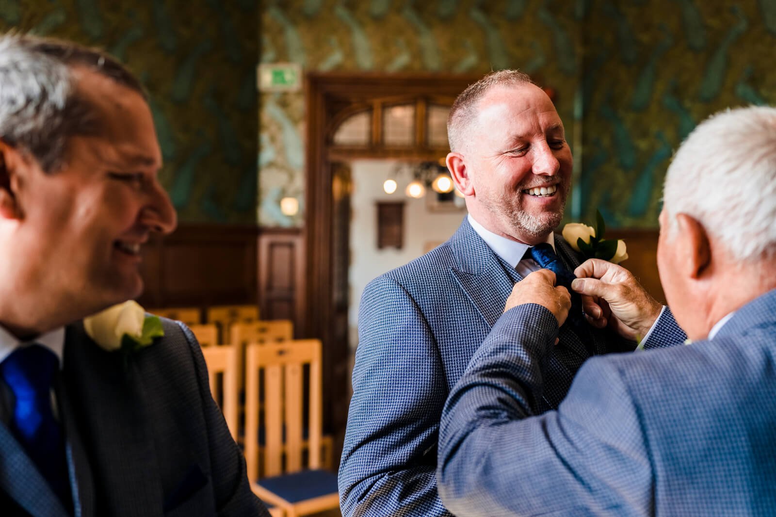 father straightens tie of groom at wedding ceremony in basing room winchester registry office