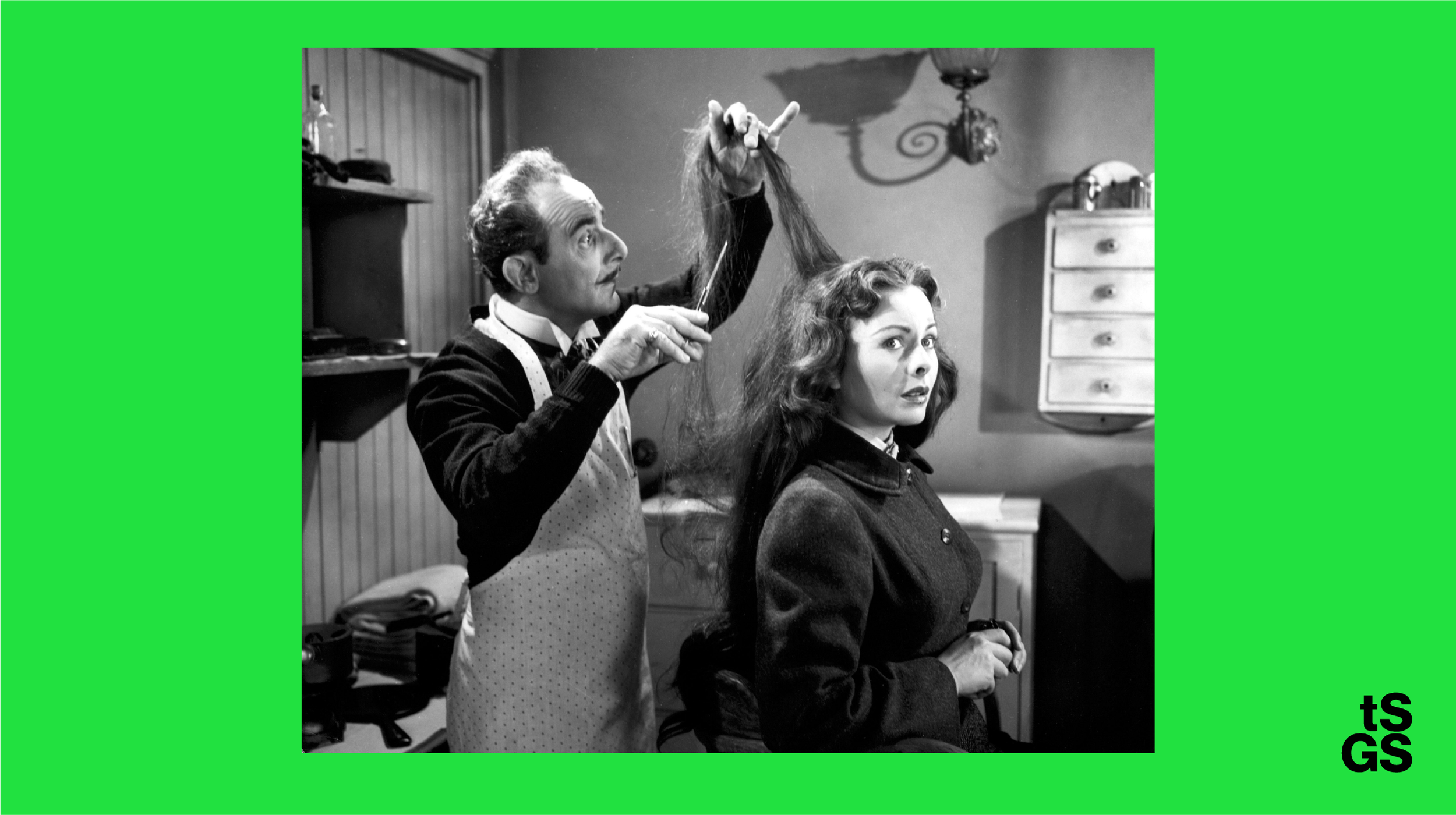 A green background with black and white photograph where a man hold up scissors and a womans hair cutting it