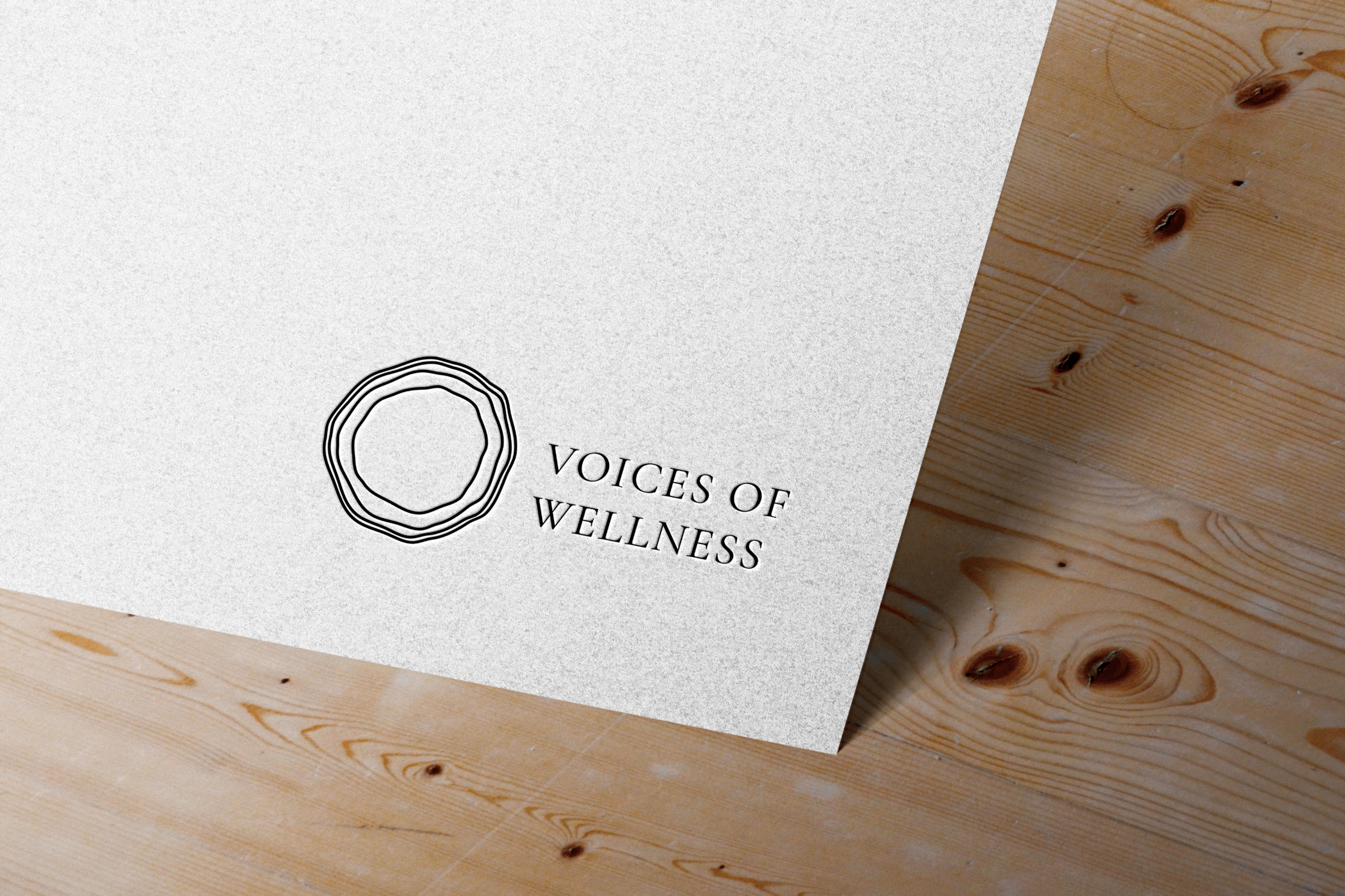 voicesofwellness-logo-wood-mockup.png