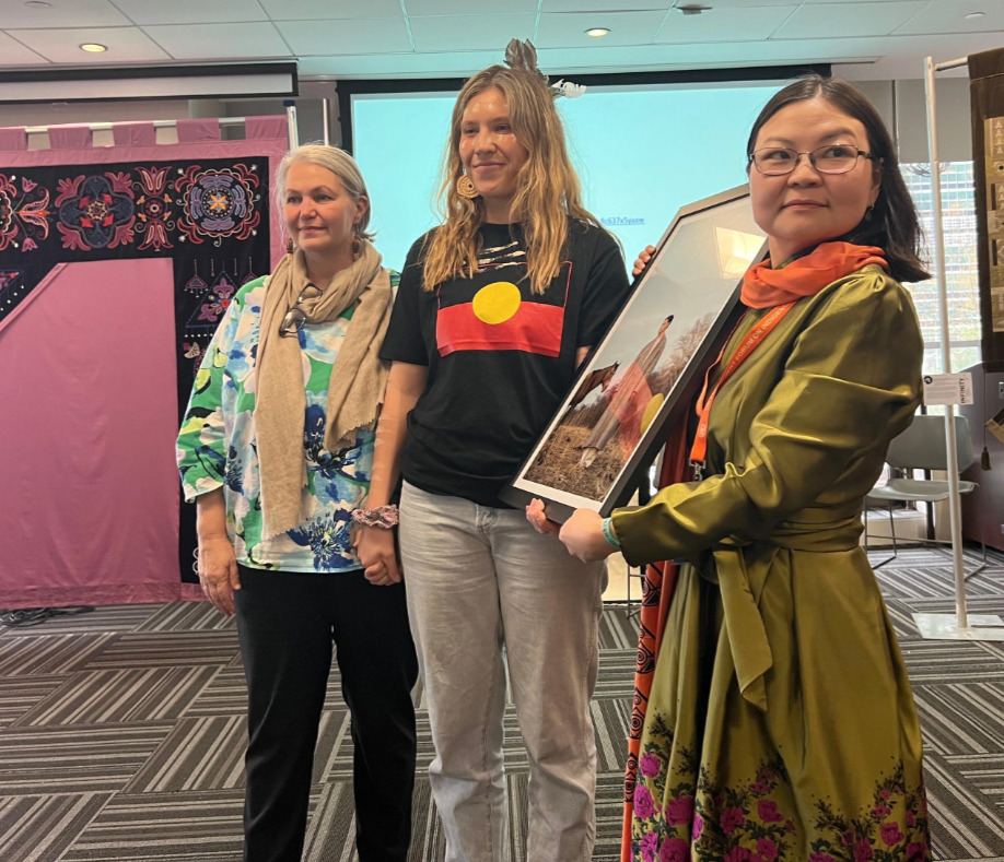  Our CEO Stephanie Harvey, and Relationship Manager Natasha Brunhuber, receiving a beautiful gift from the World Union of Indigenous Spiritual Practitioners and Wayfinders Circle 