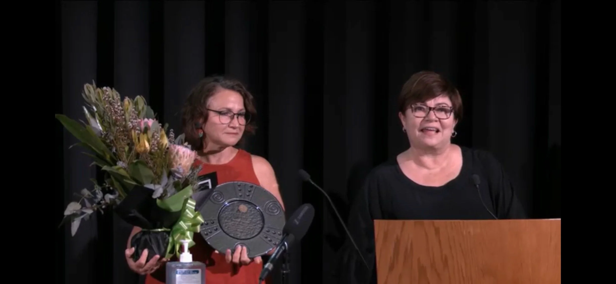  Community First Development, Director, Lauren Ganley presenting an award to Miss Donna Stephens, Community First Development, Inaugural Research and Evaluation Fellow.  