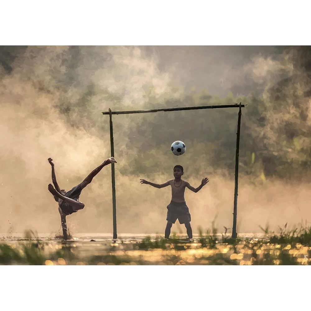 two kids playing soccer on a wet field abstract figurative print