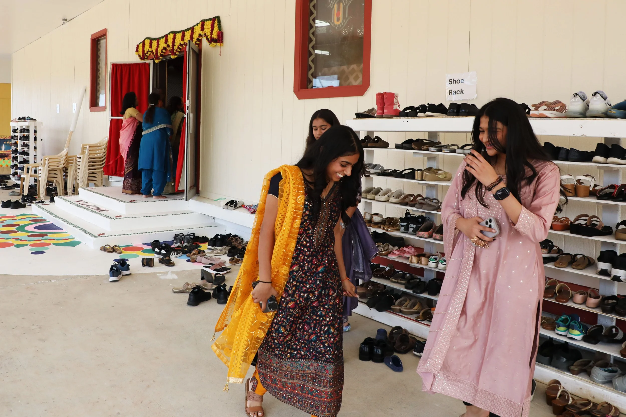  Women dressed for Diwali arrive at the celebration Oct. 27, 2024 at the BAPS Shri Swaminarayan Mandir in Newport News. Shoes collected at each entrance to the Hindu temple as people removed them before going inside. 