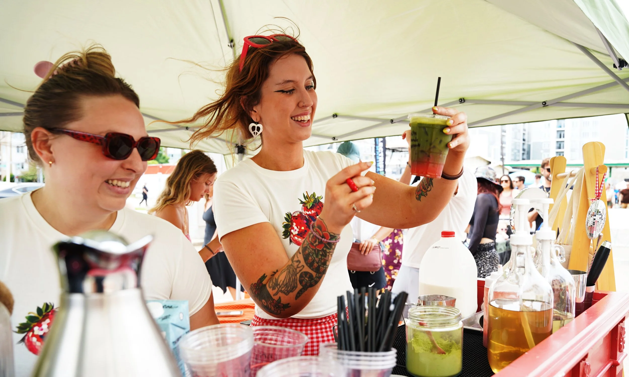  Ava Dirr, center, prepares an iced strawberry matcha latte at the Strawberry Festival at the Beach on May 17, 2025 in Virginia Beach. The rural district Pungo historically hosted a strawberry festival in the spring, a tradition ended by the COVID-19