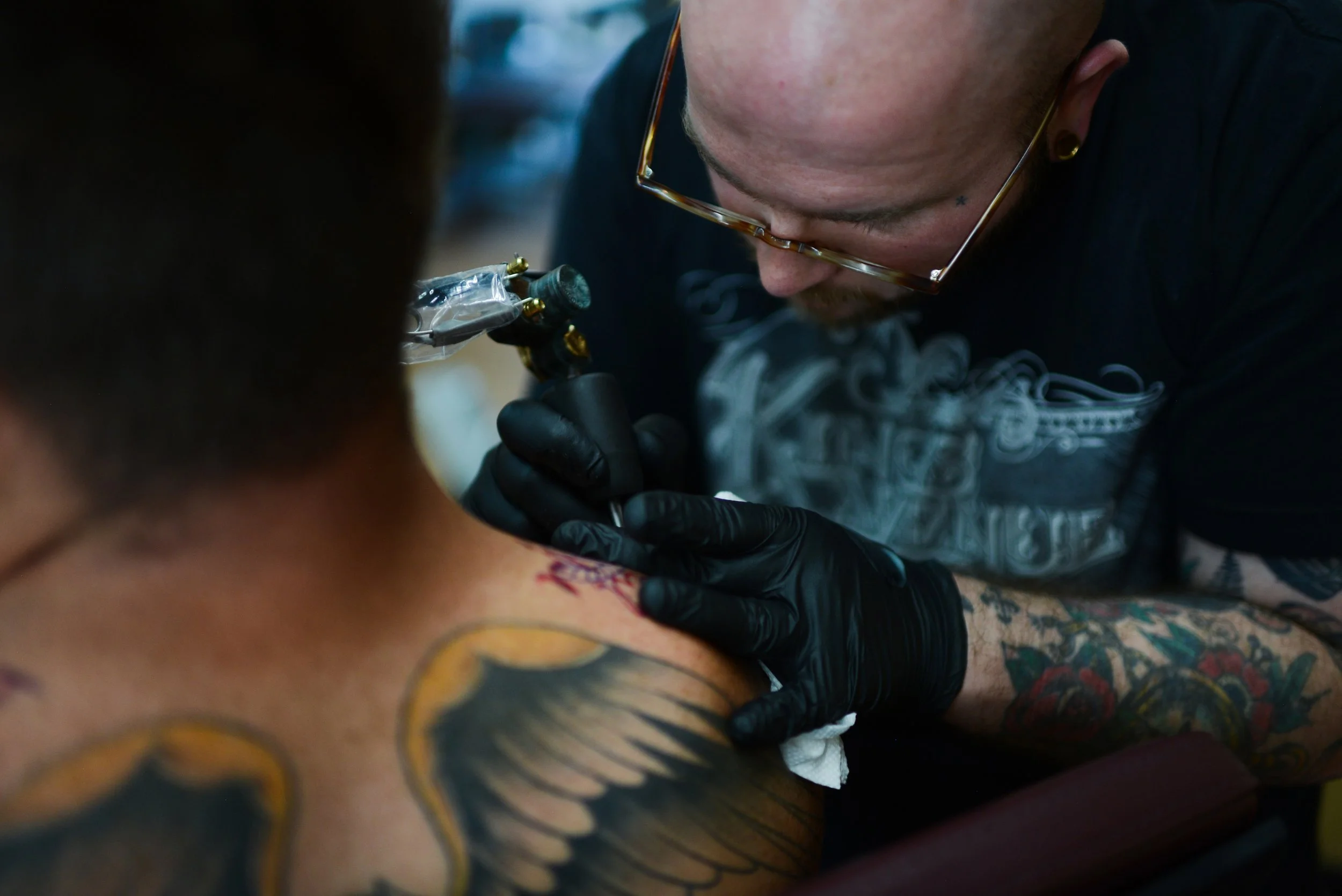  Cody Finley works on a tattoo June 23, 2021 in Ashland, MO. Finley’s shops is one of several new businesses that opened on Ashland’s revitalized main street that summer.  
