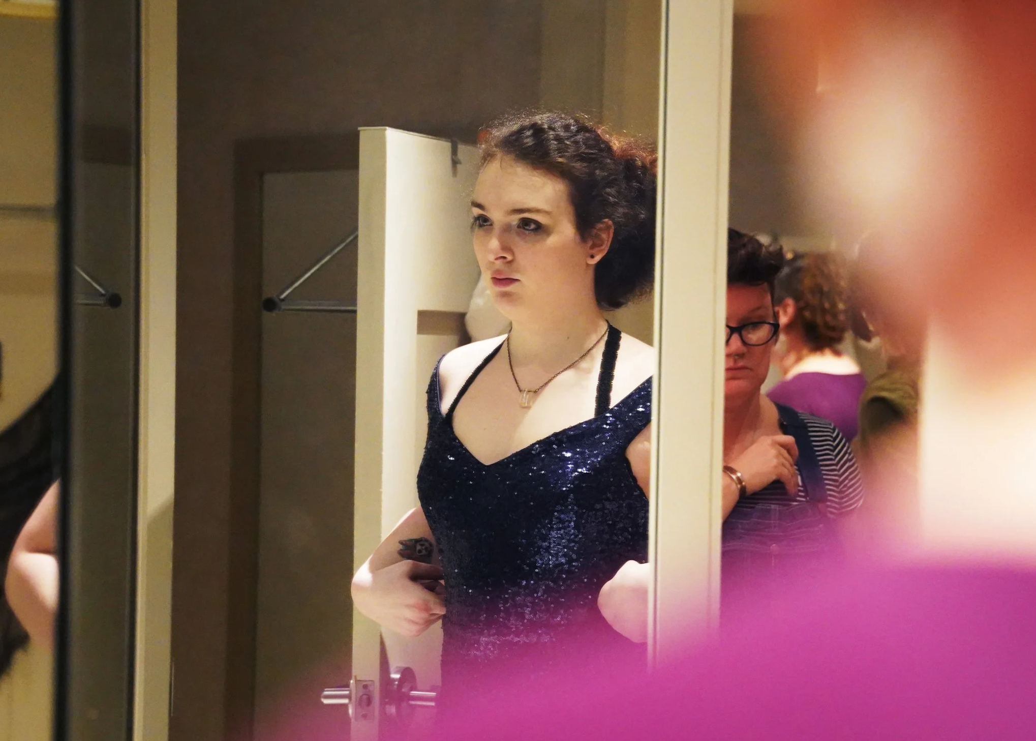  Chloe Chamberlain studies her reflection in a three-way mirror April 19, 2025 in Norfolk. Volunteers transformed a vacated J. Jill in the MacArthur Center mall into a vintage boutique for students to find outfits and make alterations ahead of Rainbo