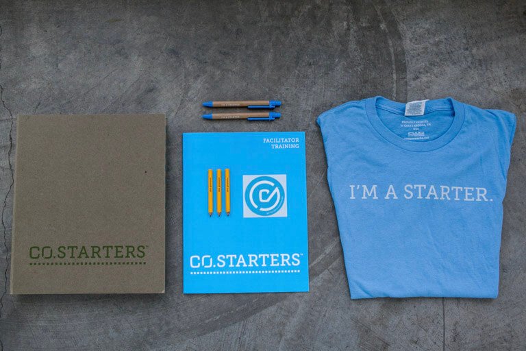 COSTARTERS materials: binder, folder and pencils, and a blue t-shirt that says "I'm a Starter"