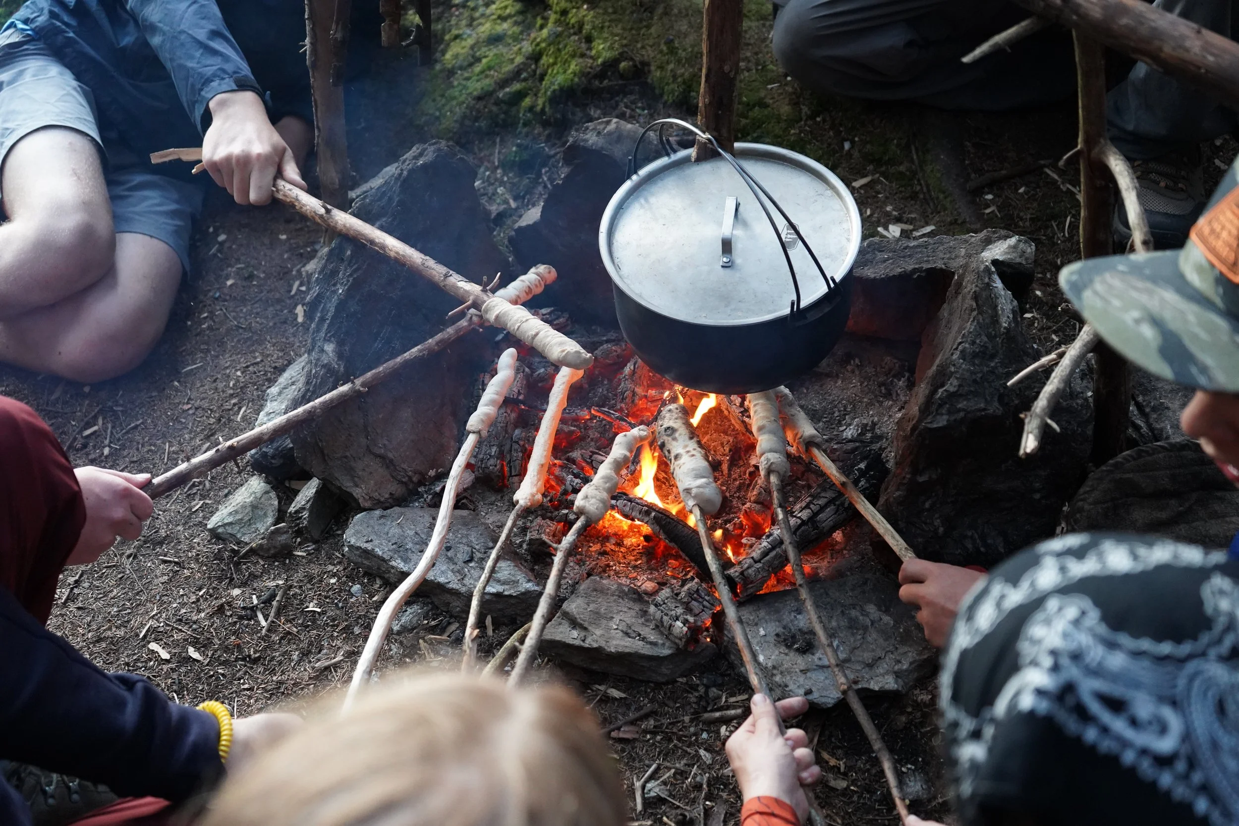 Peaks and Rivers students making bannock on the fire.JPG