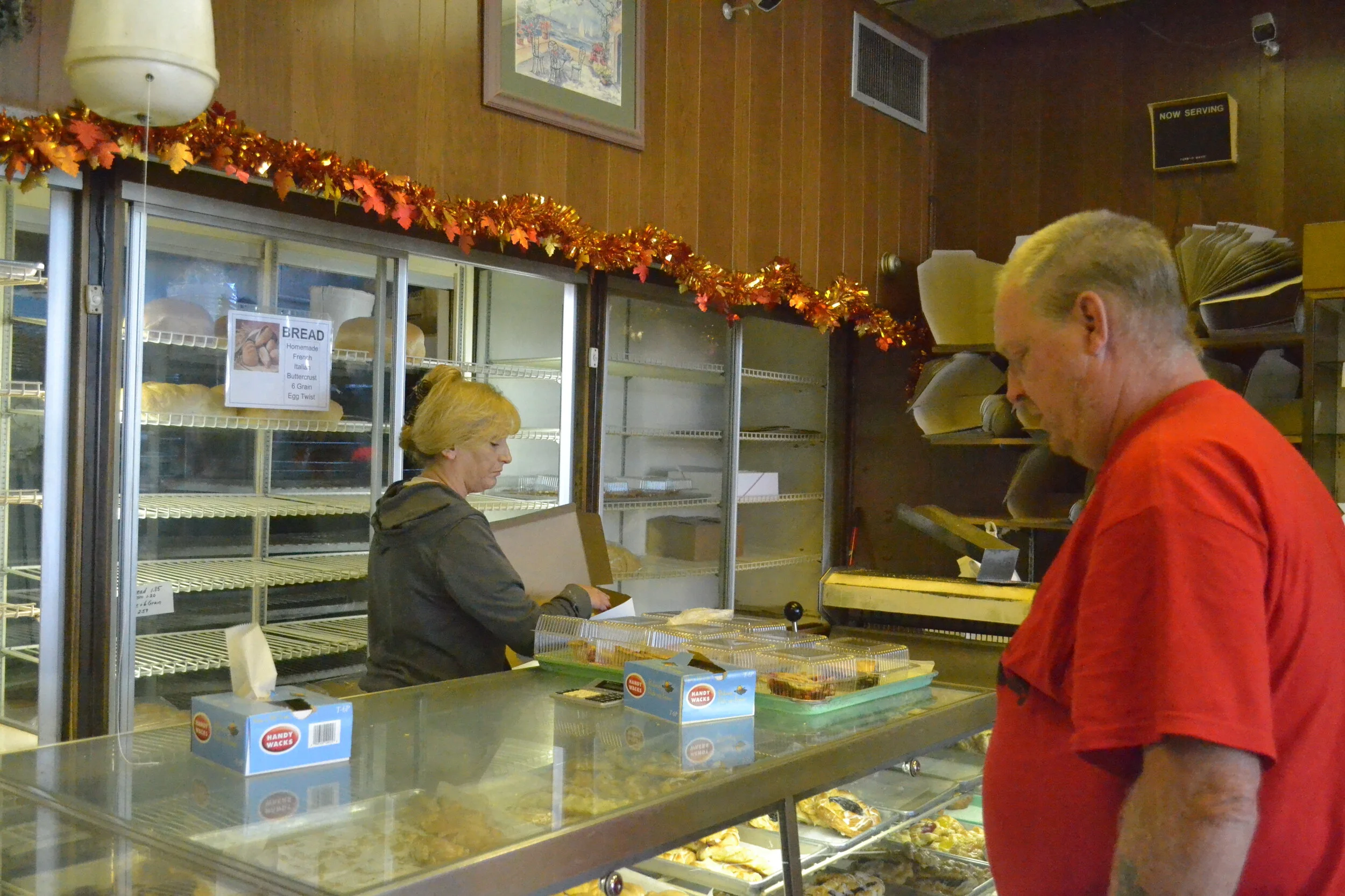 Lisa Evans a Clerk at Mantsch Blue Bonnet Bakery tending to a customer’s order. Photo credit: Tyler Polk, Point Park News Service.