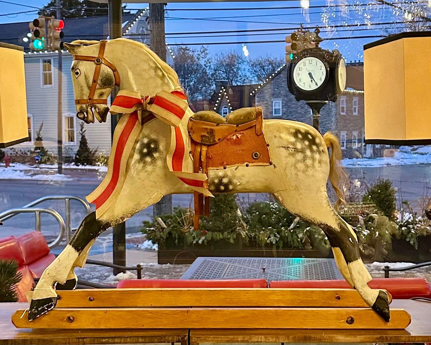 This antique glider has that quiet magic you can&rsquo;t fake&mdash;the worn paint, the hand-carved details, the way it instantly pulls you back to childhood Christmases. A true statement piece with a story to tell, especially lovely dressed for the 