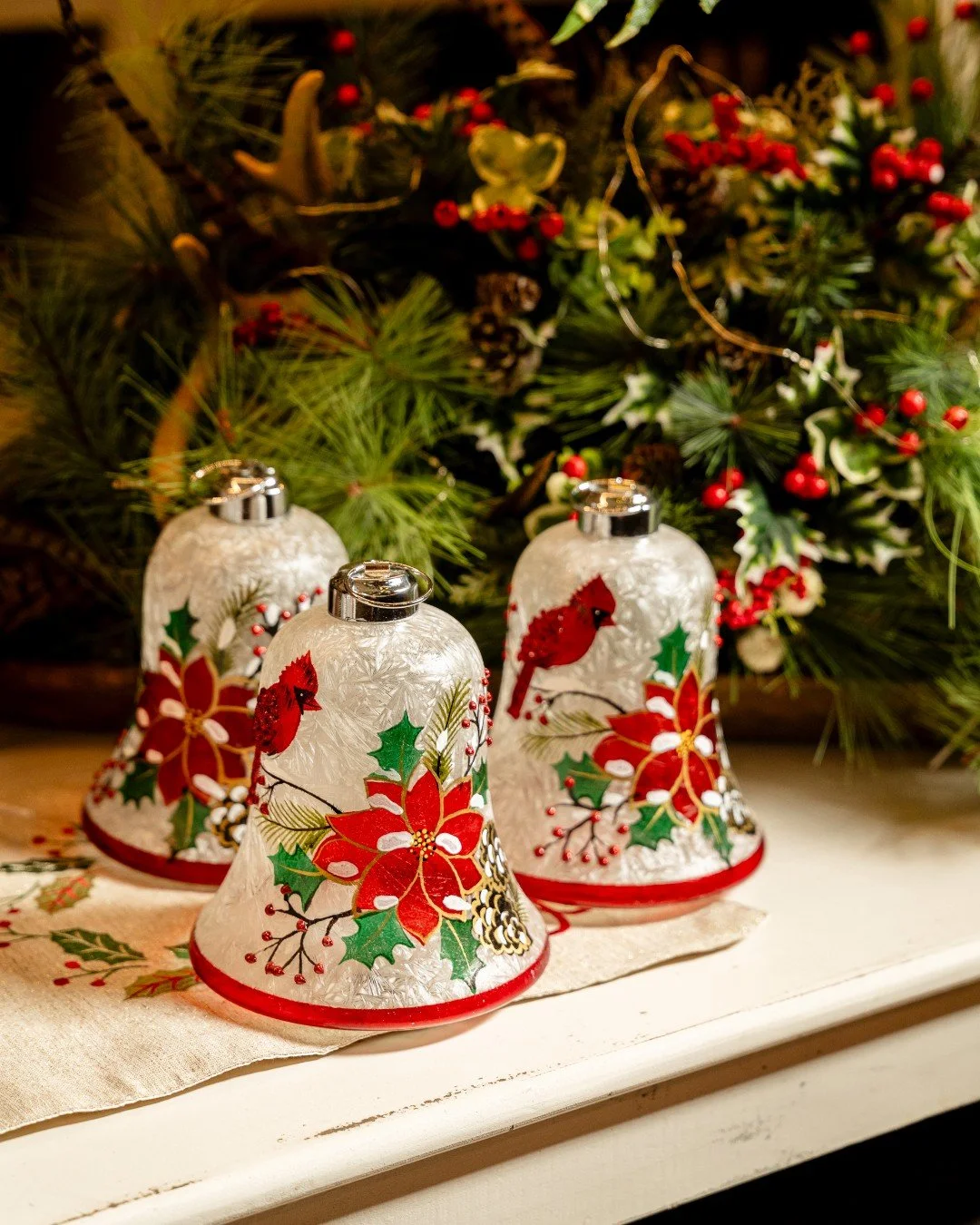 Bring a touch of holiday magic home. ❤️✨ These hand-painted glass ornaments and bells add a warm, nostalgic glow &mdash; cardinals, poinsettias, and holly capturing the beauty of the season.