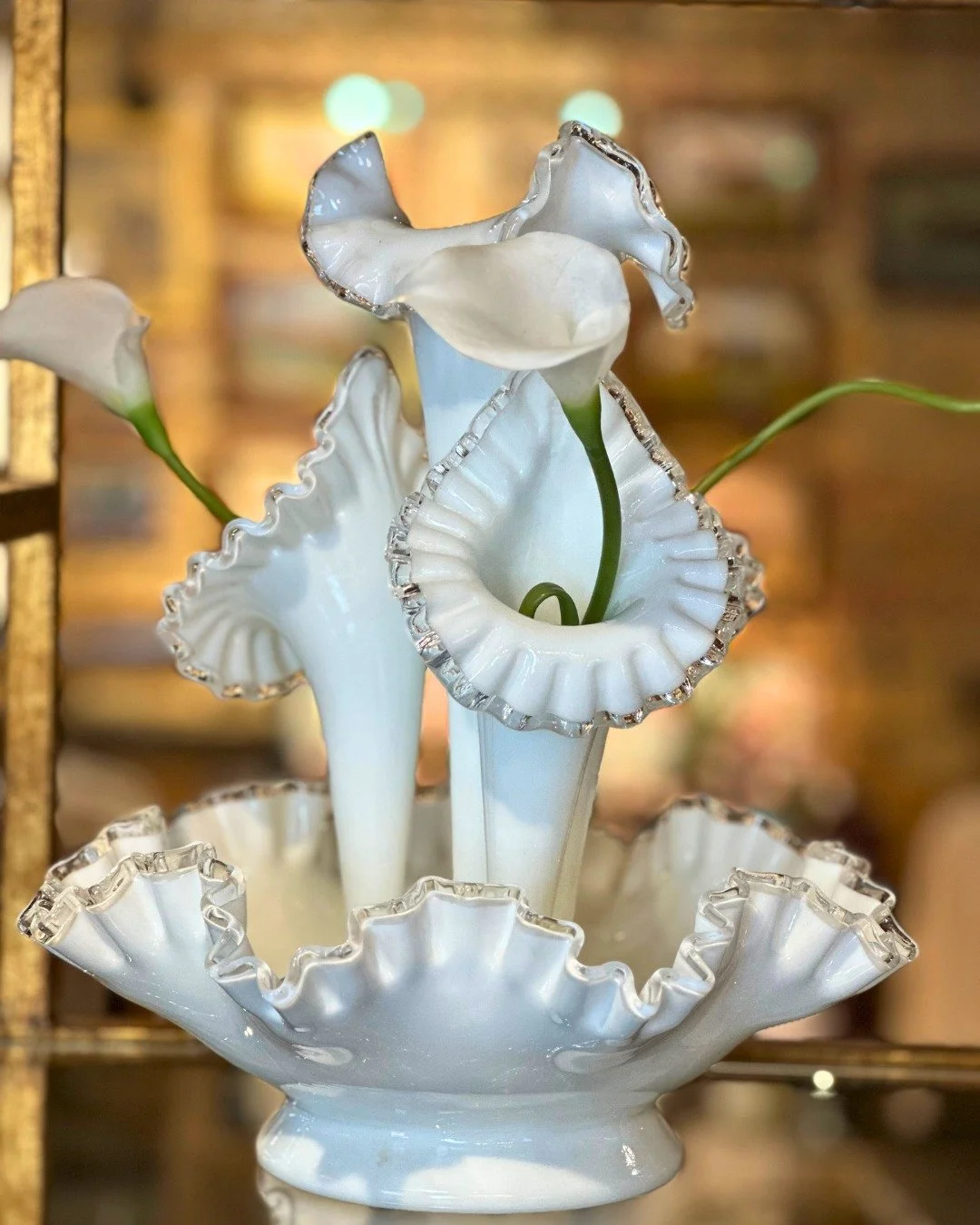 A sculptural vintage Fenton flower vase that is designed to be just as beautiful empty as it is filled.