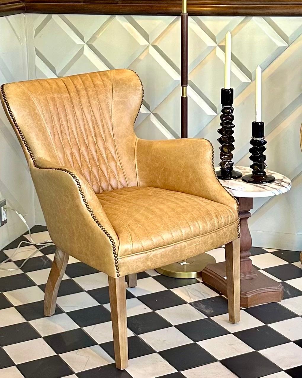 A cozy corner with plenty of character.

&bull; Leather accent chair featuring antiqued nailhead trim and rich stitched detailing
&bull; Vintage marble-top side table
&bull; Vintage green glass candlesticks

The warm leather tones, marble surface, an