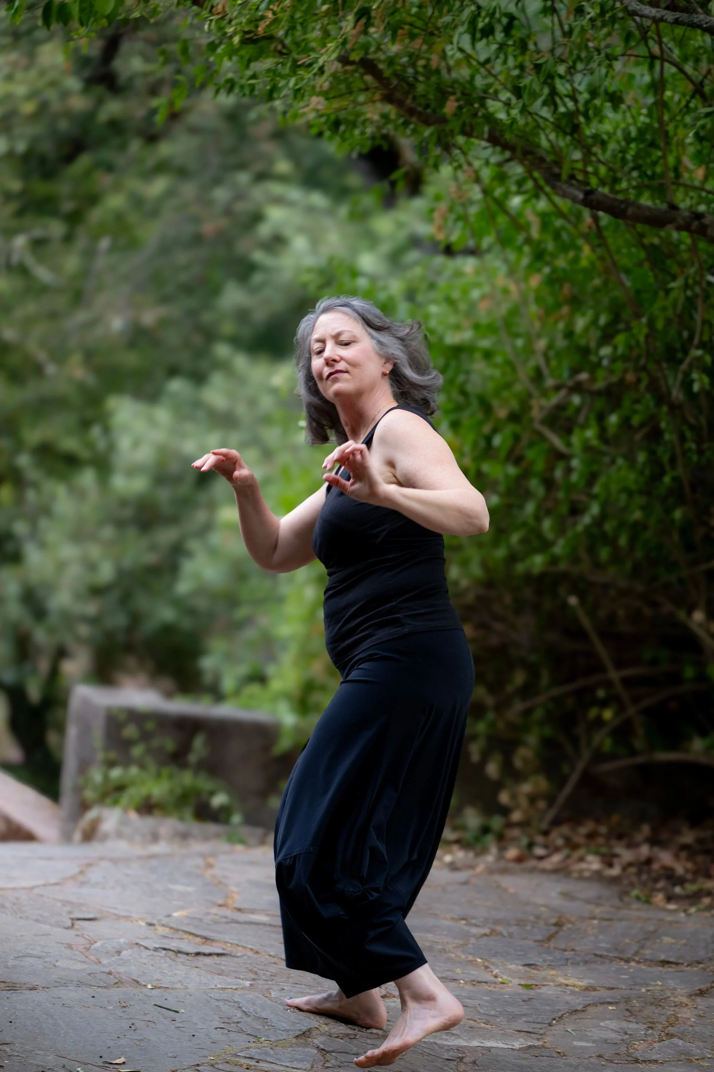 Dancer barefoot outdoors with gray hair