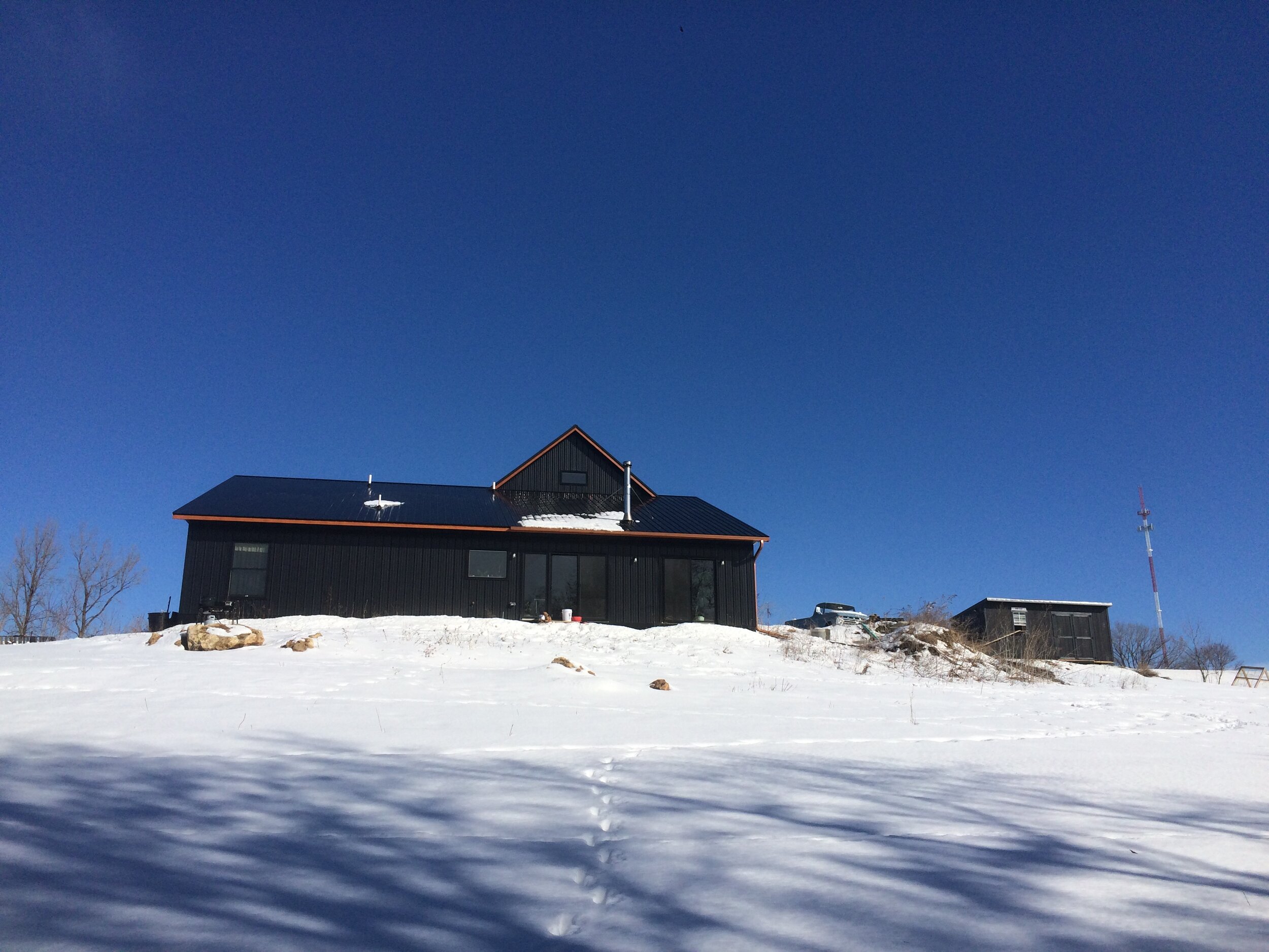 Black house in snowy field