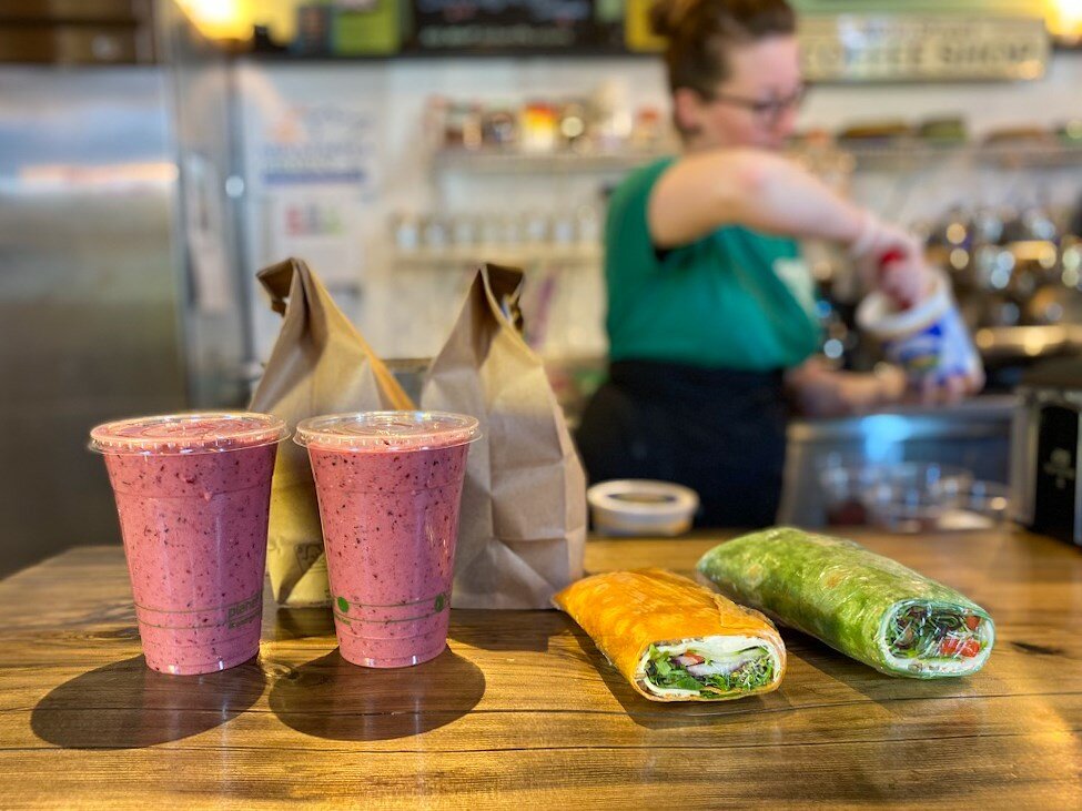 Smoothies and wraps on wood counter