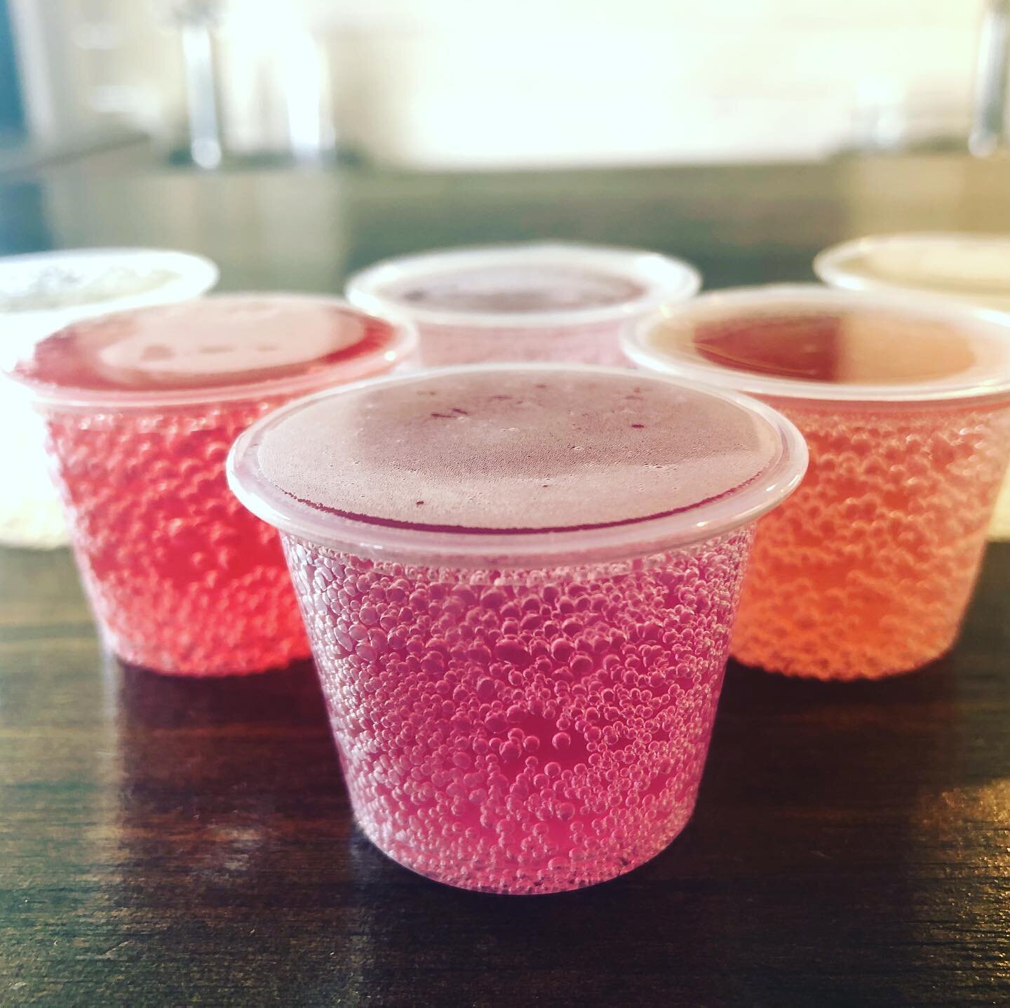 Cups of fizzy colorful kombucha